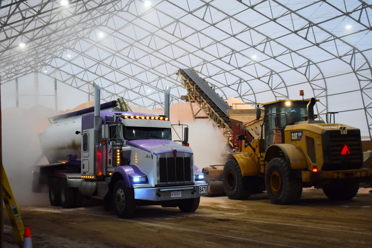 - Britespan Loader and truck moving material inside a fabric salt storage building during active operations